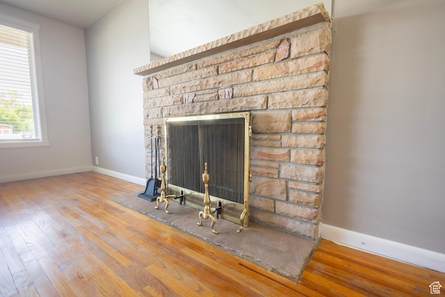 595 W Winchester St, Murray, UT 84123 - detailed view of wood finished floors, baseboards, and a fireplace