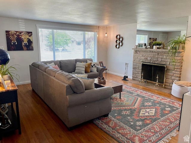 595 W Winchester St, Murray, UT 84123 - living area with wood finished floors, baseboards, and a stone fireplace