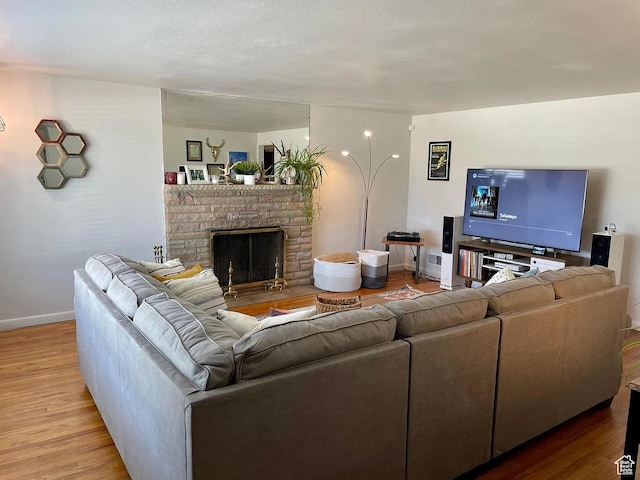 595 W Winchester St, Murray, UT 84123 - living area with wood finished floors, baseboards, and a stone fireplace