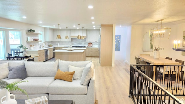 5757 S Surreyrun Rd, Murray, UT 84107 - living area with light wood-style flooring, a chandelier, baseboards, and recessed lighting