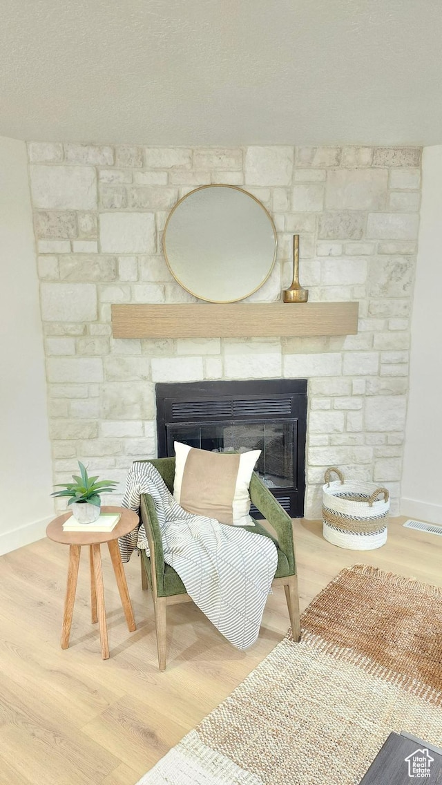 5757 S Surreyrun Rd, Murray, UT 84107 - detailed view of a stone fireplace, baseboards, and wood finished floors