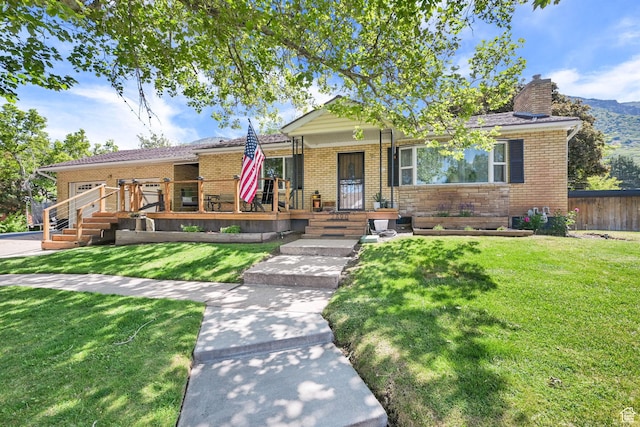 2890 Wheelock Ave, Ogden, UT 84403 - view of front of property featuring brick siding, a chimney, and a porch