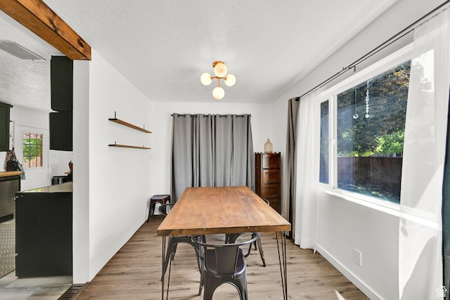 2890 Wheelock Ave, Ogden, UT 84403 - dining space featuring a textured ceiling and light wood-style flooring
