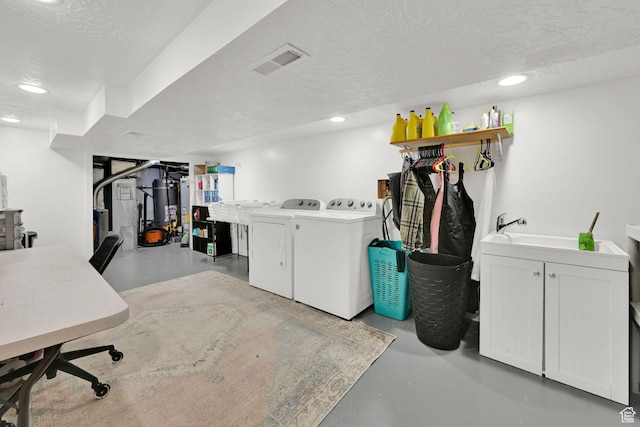 2890 Wheelock Ave, Ogden, UT 84403 - finished below grade area featuring separate washer and dryer, a textured ceiling, recessed lighting, and gas water heater