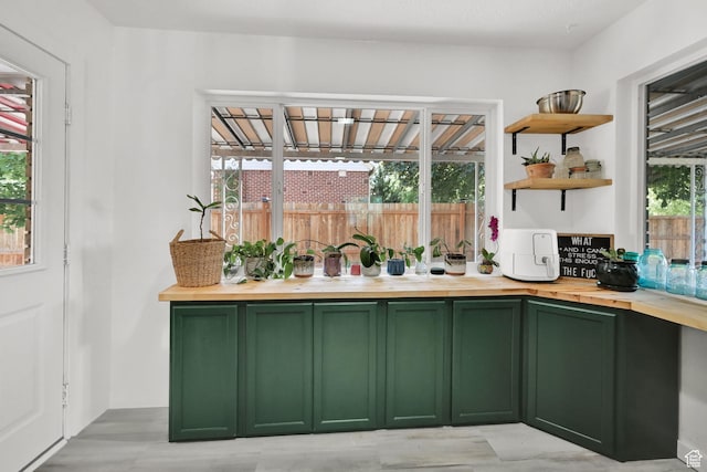 2890 Wheelock Ave, Ogden, UT 84403 - kitchen with green cabinetry, butcher block countertops, and open shelves