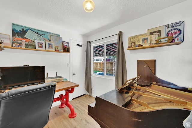 2890 Wheelock Ave, Ogden, UT 84403 - home office featuring wood finished floors, a textured ceiling, and baseboards