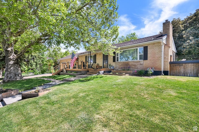 2890 Wheelock Ave, Ogden, UT 84403 - view of front of property featuring a chimney, brick siding, and covered porch