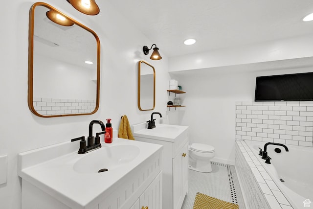 2890 Wheelock Ave, Ogden, UT 84403 - bathroom featuring tiled tub, tile patterned flooring, two vanities, toilet, and recessed lighting