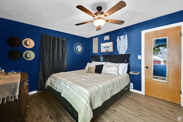 2890 Wheelock Ave, Ogden, UT 84403 - bedroom featuring wood finished floors, a textured ceiling, baseboards, and ceiling fan