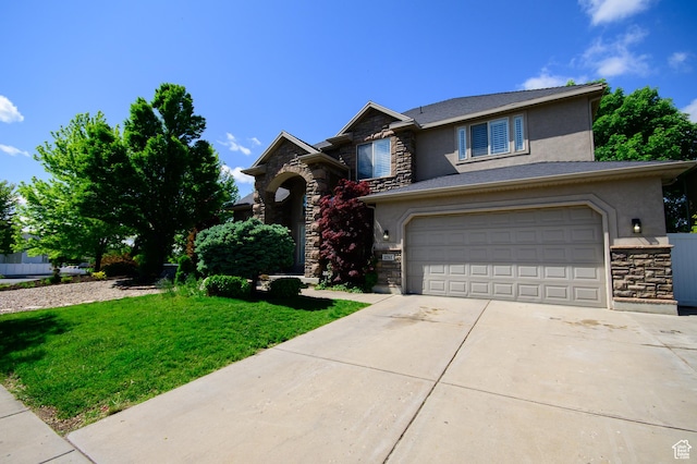 2763 N Hills Dr, Layton, UT 84040 - view of front of home with stone siding, stucco siding, driveway, and a front lawn