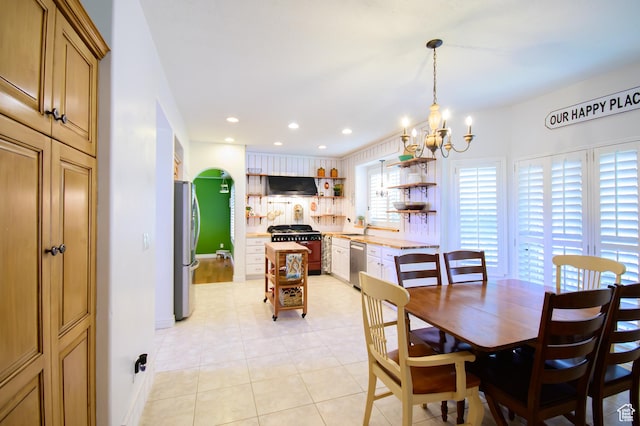 2763 N Hills Dr, Layton, UT 84040 - dining space with a chandelier, light tile patterned flooring, recessed lighting, arched walkways, and baseboards