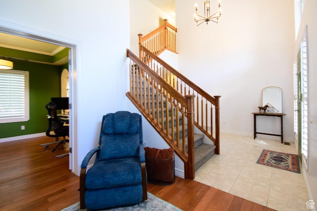 2763 N Hills Dr, Layton, UT 84040 - stairs featuring a chandelier, ornamental molding, wood finished floors, baseboards, and a towering ceiling