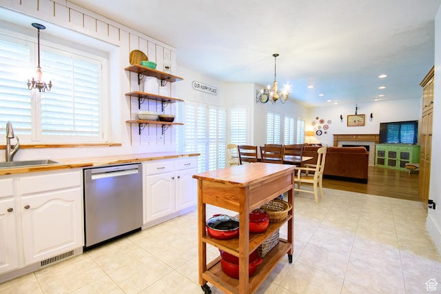 2763 N Hills Dr, Layton, UT 84040 - kitchen featuring stainless steel dishwasher, a chandelier, a sink, open shelves, and white cabinets