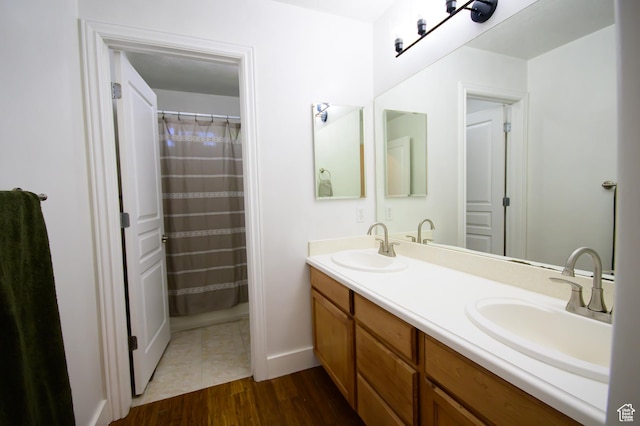 2763 N Hills Dr, Layton, UT 84040 - full bathroom featuring double vanity, wood finished floors, and baseboards