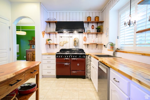 2763 N Hills Dr, Layton, UT 84040 - kitchen featuring butcher block counters, under cabinet range hood, a sink, range with two ovens, and dishwasher