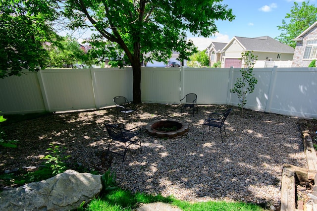 2763 N Hills Dr, Layton, UT 84040 - fenced backyard with an outdoor fire pit