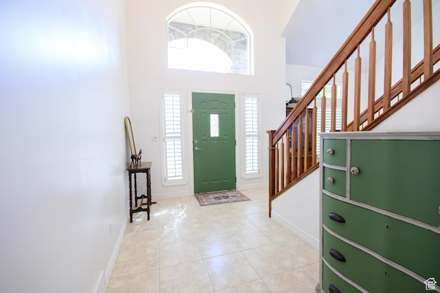 2763 N Hills Dr, Layton, UT 84040 - foyer entrance featuring baseboards, a high ceiling, stairway, and tile patterned flooring