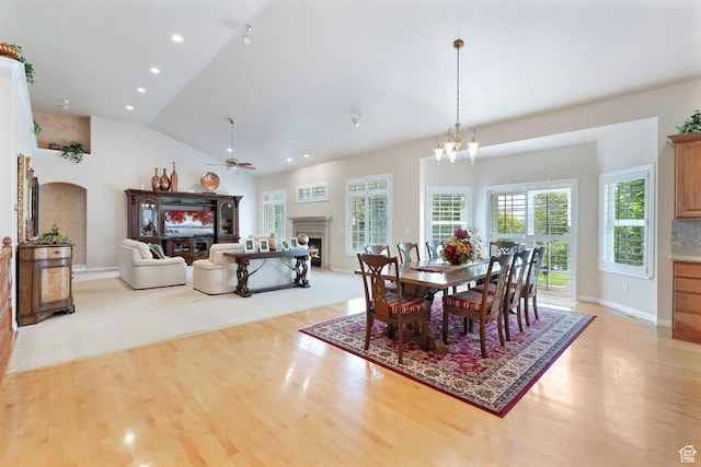 531 W Glendon Way, Pleasant Grove, UT 84062 - dining space with light wood-type flooring, a warm lit fireplace, a ceiling fan, lofted ceiling, and recessed lighting