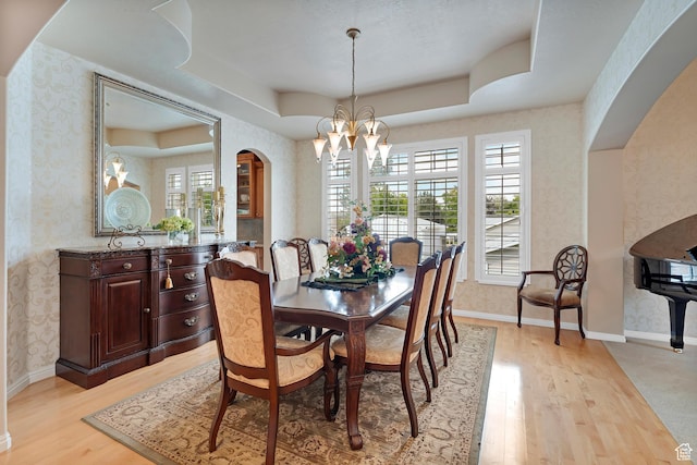 531 W Glendon Way, Pleasant Grove, UT 84062 - dining room with wallpapered walls, arched walkways, a chandelier, a raised ceiling, and light wood finished floors