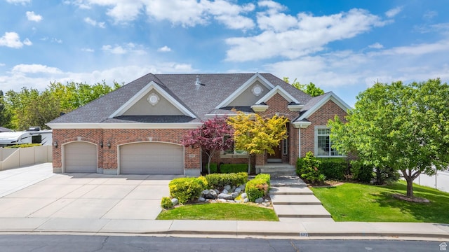 531 W Glendon Way, Pleasant Grove, UT 84062 - view of front facade with an attached garage, concrete driveway, brick siding, and roof with shingles