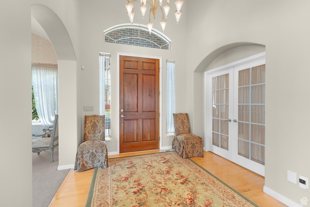 531 W Glendon Way, Pleasant Grove, UT 84062 - entrance foyer with wood finished floors, french doors, arched walkways, a towering ceiling, and baseboards