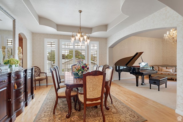 531 W Glendon Way, Pleasant Grove, UT 84062 - dining space featuring wallpapered walls, a chandelier, arched walkways, light wood-type flooring, and baseboards