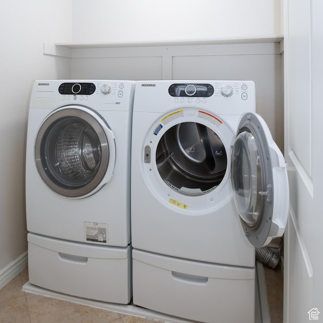 917 E Grape Ivy Way S, Millcreek, UT 84106 - laundry room featuring washing machine and clothes dryer and light tile patterned floors