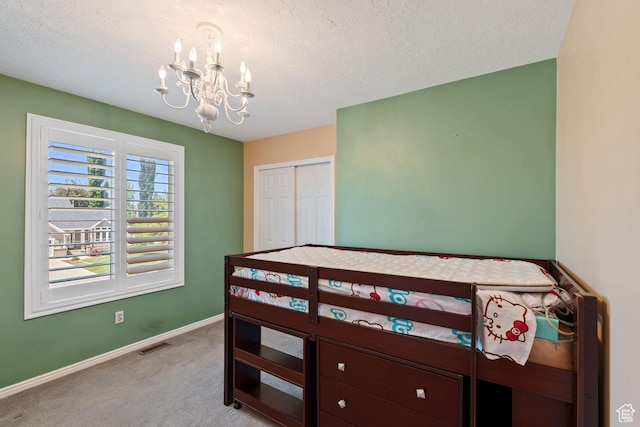 1516 N Willow Valley Dr W, Centerville, UT 84014 - bedroom with a chandelier, light carpet, a textured ceiling, baseboards, and a closet