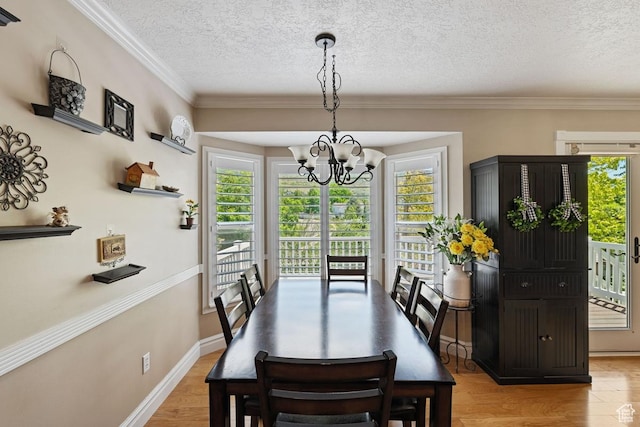 1516 N Willow Valley Dr W, Centerville, UT 84014 - dining area featuring a chandelier, plenty of natural light, a textured ceiling, ornamental molding, and baseboards