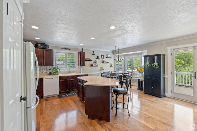 1516 N Willow Valley Dr W, Centerville, UT 84014 - kitchen featuring white appliances, a sink, plenty of natural light, a kitchen island, and a textured ceiling