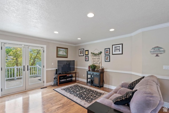1516 N Willow Valley Dr W, Centerville, UT 84014 - living area featuring a textured ceiling, wood finished floors, french doors, recessed lighting, and crown molding