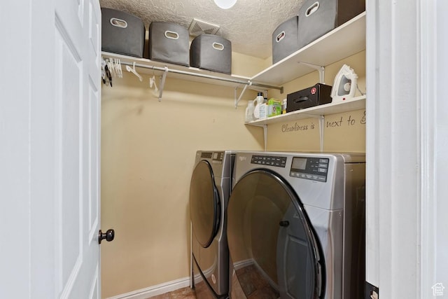 1516 N Willow Valley Dr W, Centerville, UT 84014 - laundry area featuring separate washer and dryer, a textured ceiling, and baseboards