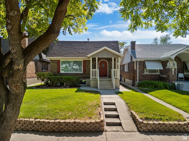 1067 S 400 E, Salt Lake City, UT 84111 - view of front facade featuring brick siding and a front yard