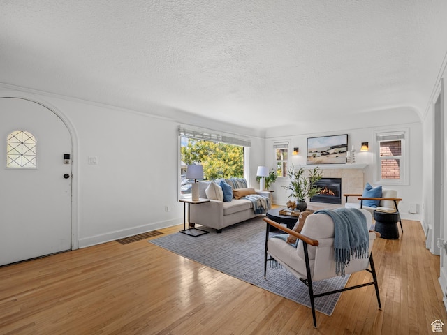1067 S 400 E, Salt Lake City, UT 84111 - living area with wood-type flooring, a fireplace, and a textured ceiling