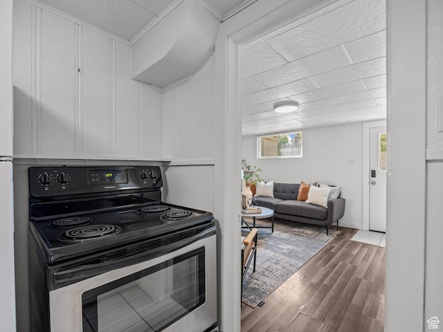 1067 S 400 E, Salt Lake City, UT 84111 - kitchen featuring stainless steel electric range oven, wood finished floors, and white cabinetry