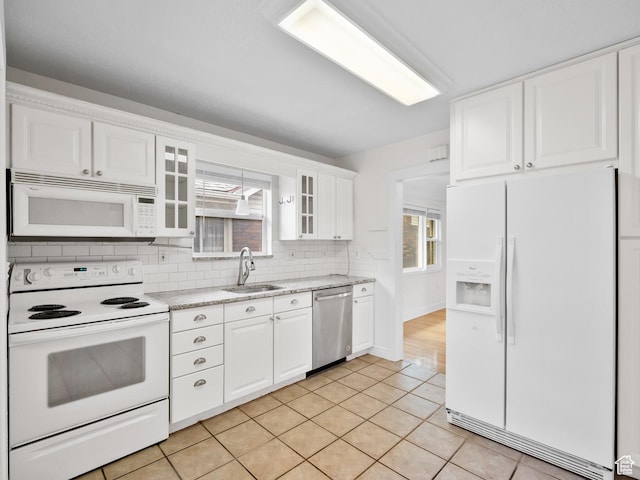 1067 S 400 E, Salt Lake City, UT 84111 - kitchen featuring white appliances, backsplash, white cabinets, glass insert cabinets, and light tile patterned floors