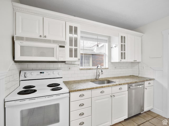 1067 S 400 E, Salt Lake City, UT 84111 - kitchen featuring white appliances, white cabinetry, glass insert cabinets, and tasteful backsplash