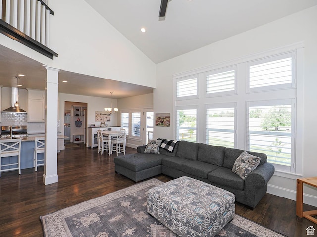104 S Summer Breeze Ln W, Layton, UT 84041 - living area with high vaulted ceiling, dark wood-type flooring, decorative columns, baseboards, and a ceiling fan