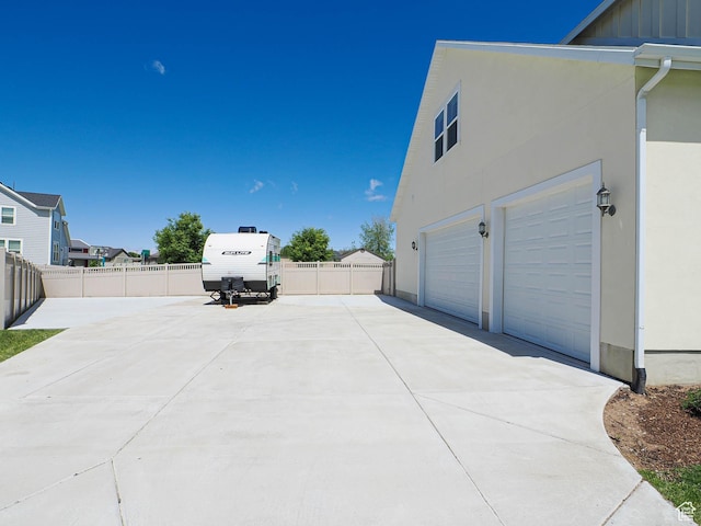 104 S Summer Breeze Ln W, Layton, UT 84041 - view of property exterior featuring stucco siding, driveway, an attached garage, and board and batten siding