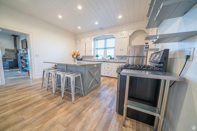 59 E 300 N, Ephraim, UT 84627 - kitchen featuring appliances with stainless steel finishes, a kitchen island, recessed lighting, white cabinets, and light wood-type flooring