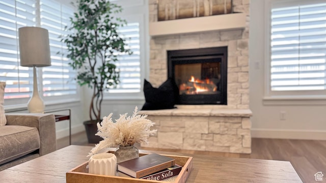 864 S 1260 W Unit 129, Heber City, UT 84032 - living room with baseboards, healthy amount of natural light, a lit fireplace, and wood finished floors