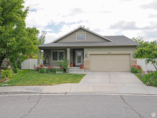 3129 S Eagle Rock Way W, West Valley City, UT 84120 - view of front of property with stucco siding, driveway, an attached garage, and stone siding