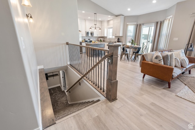 4957 N Sage Dr, Eagle Mountain, UT 84005 - staircase with wood finished floors, lofted ceiling, recessed lighting, and baseboards