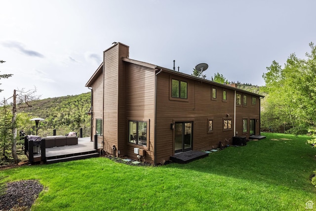 7189 N Hitching Post Dr W, Park City, UT 84098 - rear view of house featuring a chimney, a yard, a wooden deck, and central air condition unit