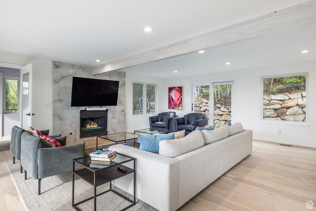 7189 N Hitching Post Dr W, Park City, UT 84098 - living area featuring recessed lighting, light wood finished floors, beamed ceiling, a premium fireplace, and baseboards