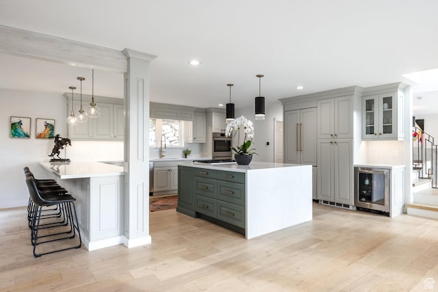 7189 N Hitching Post Dr W, Park City, UT 84098 - kitchen with oven, light countertops, beverage cooler, recessed lighting, and light wood-type flooring