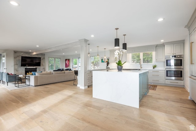 7189 N Hitching Post Dr W, Park City, UT 84098 - kitchen with double oven, recessed lighting, light countertops, a center island, and light wood-style flooring