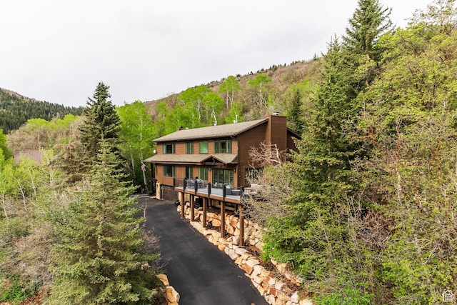 7189 N Hitching Post Dr W, Park City, UT 84098 - view of front facade with a chimney and a view of trees