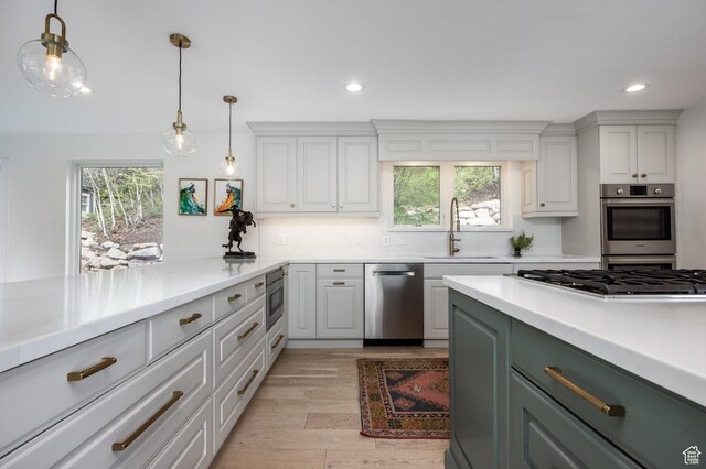 7189 N Hitching Post Dr W, Park City, UT 84098 - kitchen featuring a sink, appliances with stainless steel finishes, light countertops, recessed lighting, and hanging light fixtures