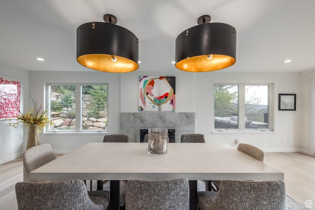 7189 N Hitching Post Dr W, Park City, UT 84098 - dining room with a high end fireplace, baseboards, light wood-type flooring, and recessed lighting
